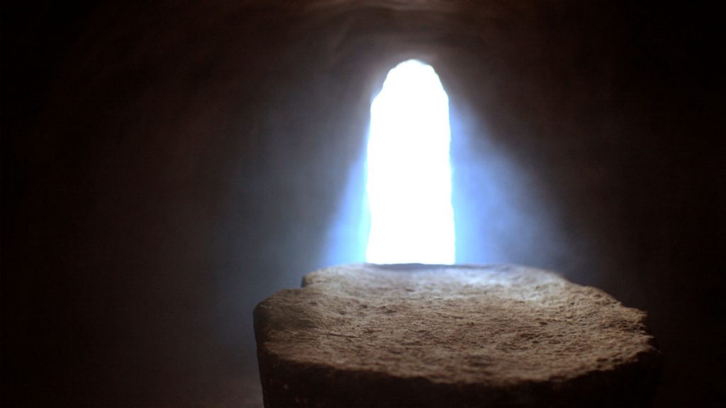 light shining through the door illuminating an empty tomb