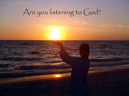 Girl standing on a beach at sunset, holding the sun in her hands with caption "Are you listening to God?"