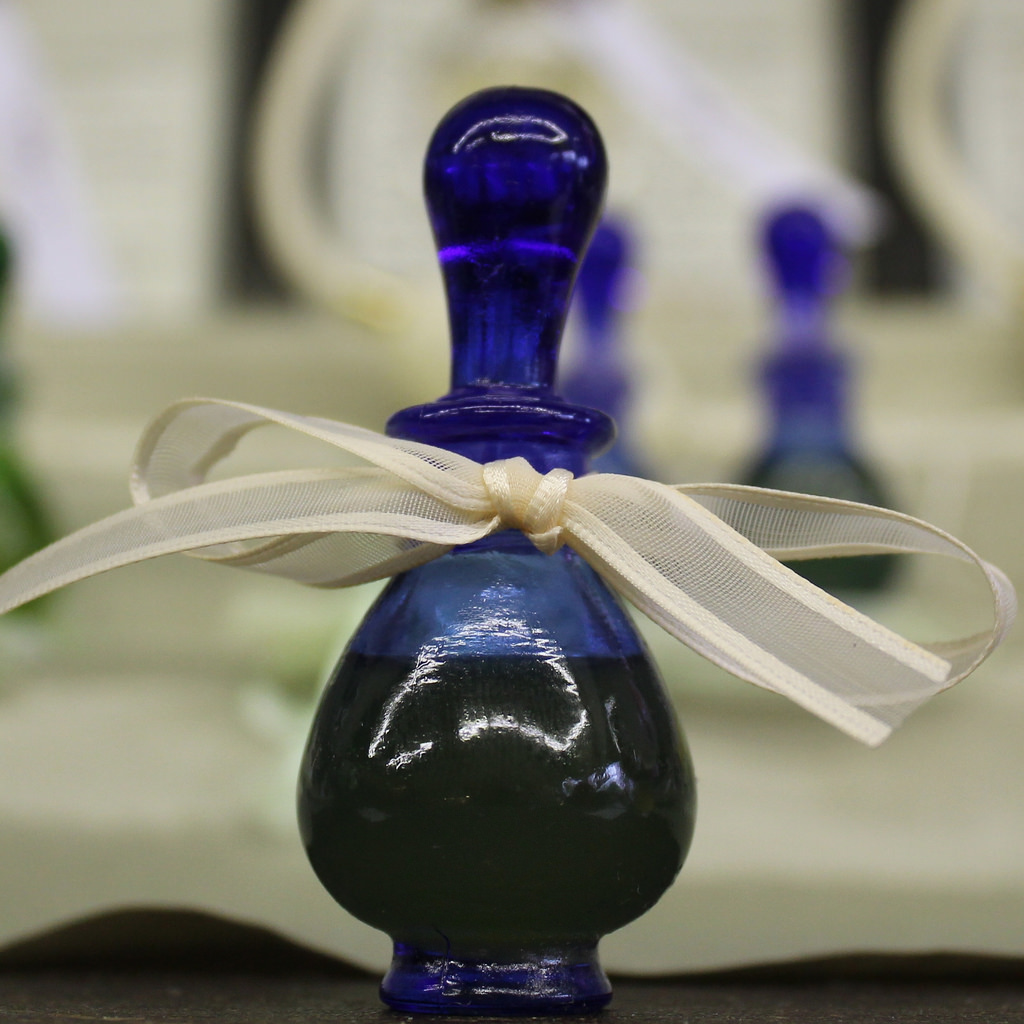 jar of perfume in blue designer bottle