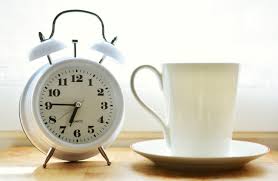 alarm clock and coffee cup