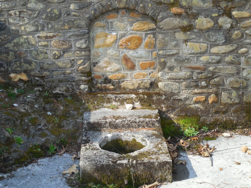 abandoned cistern made out of brick and rock