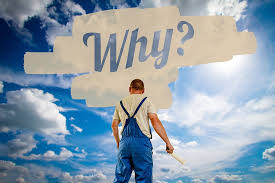 man in overalls with his back facing us and the word WHY? written in a thought bubble above his head, blue sky in the background