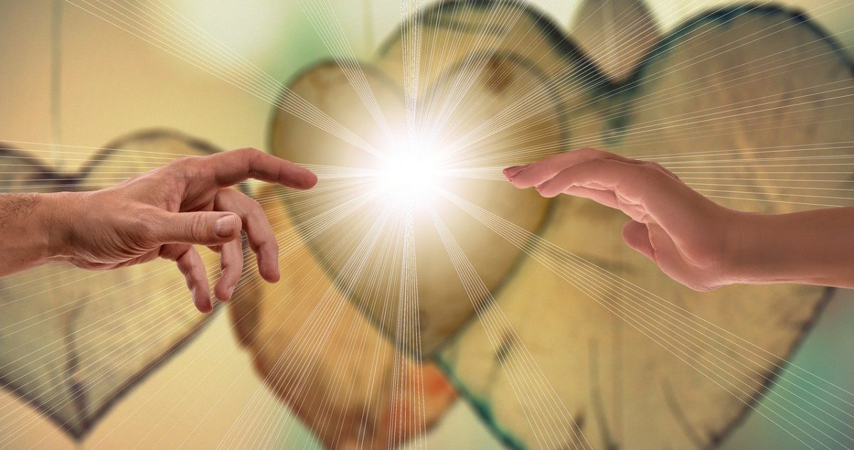 hearts overlaid by the "Creation of Adam" hands with light ball between their hands
