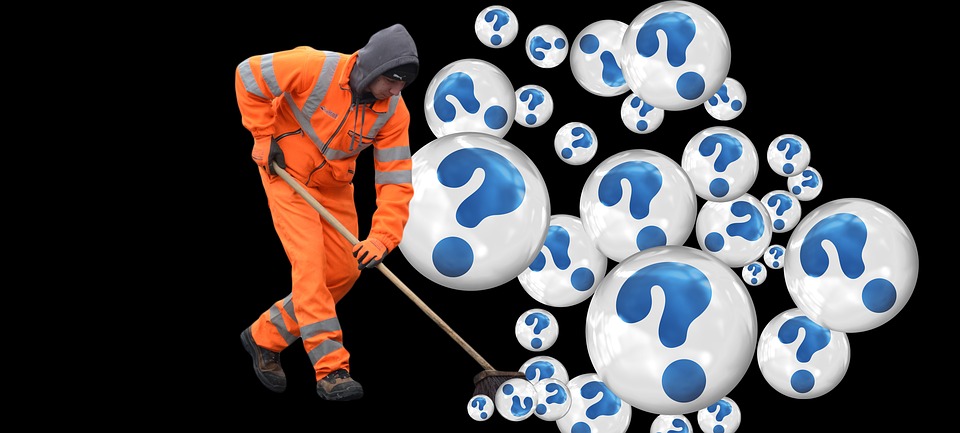 garbage worker brushing question mark bubbles into a pile