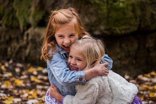 two little girls hugging with joy