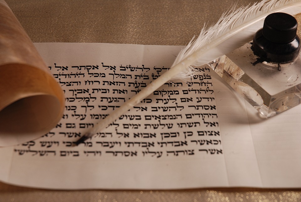 quill and scroll paper with Hebrew writing