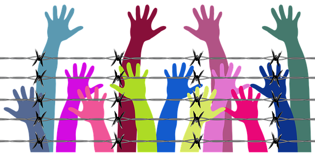 graphic of colorful hands reach up above barbed wire fence