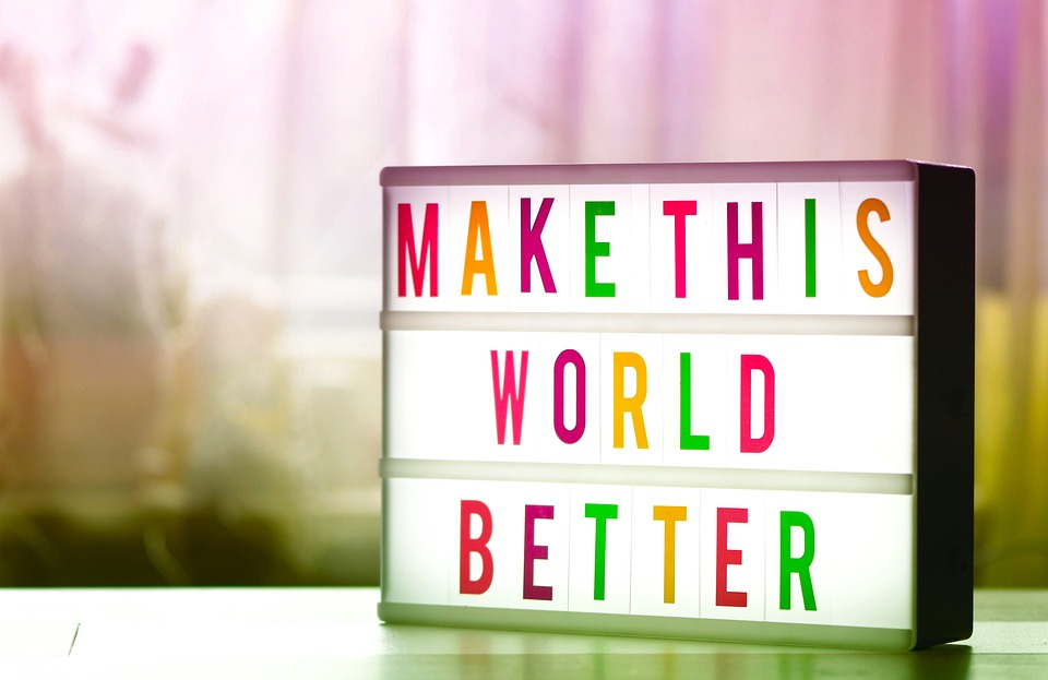 sign with colorful lettering that says Make This World Better