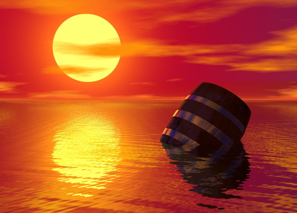 barrel floating in the water with the moon and orange sky behind it